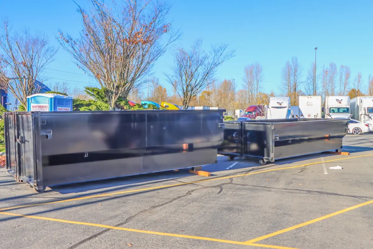 Professional dumpster rental service with roll-off container on residential driveway in Spring Valley Lake